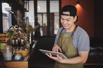 asian-man-barista-holding-tablet-for-checking-order-from-customer-on-coffee-cafe